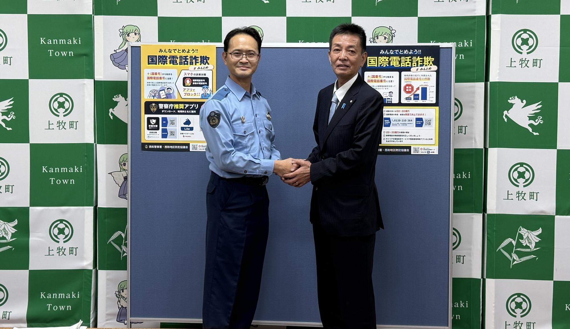 西和消防署長と町長が握手する様子